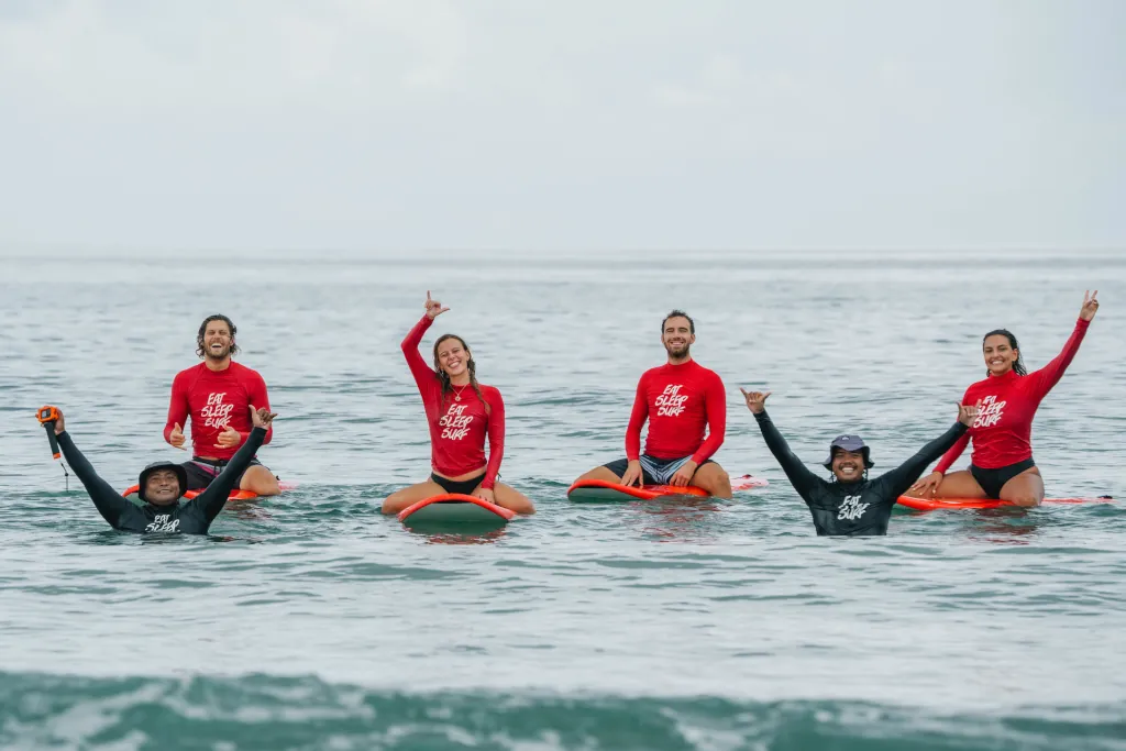 Group of beginner surfers together