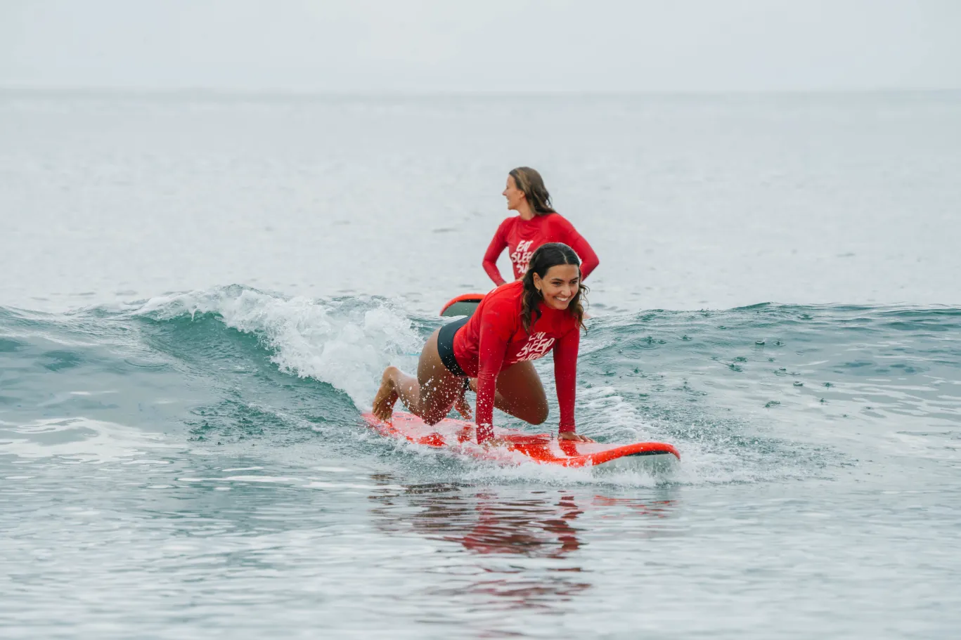 a happy surfer catching her first real wave