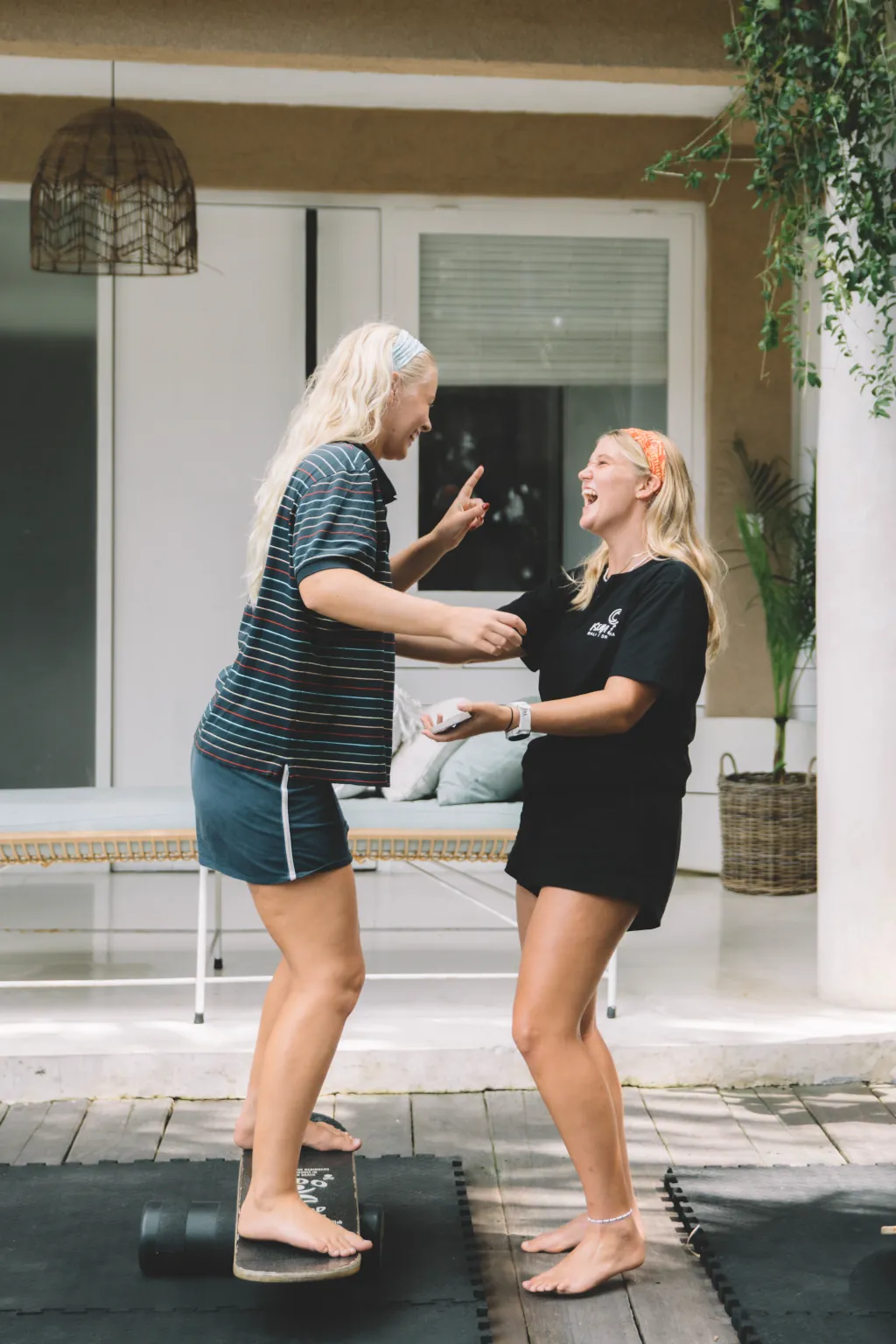 happy girls smiling in Seminyak while practicing the balance board