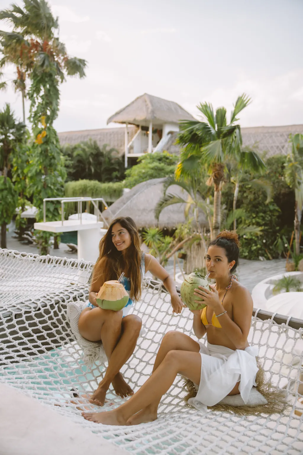 Two girls in hammocks. Calm and easy lifestyle at Kima surf Canggu