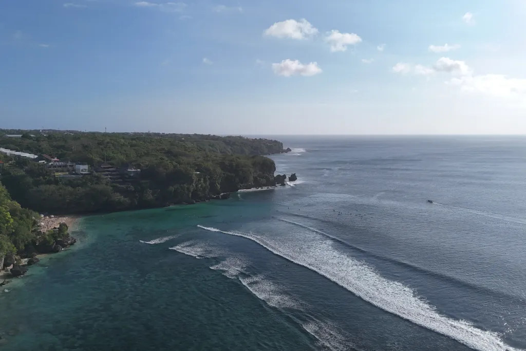 A drone shot of Padang Padang, crystal clear water, white sand beaches and a sunny day.