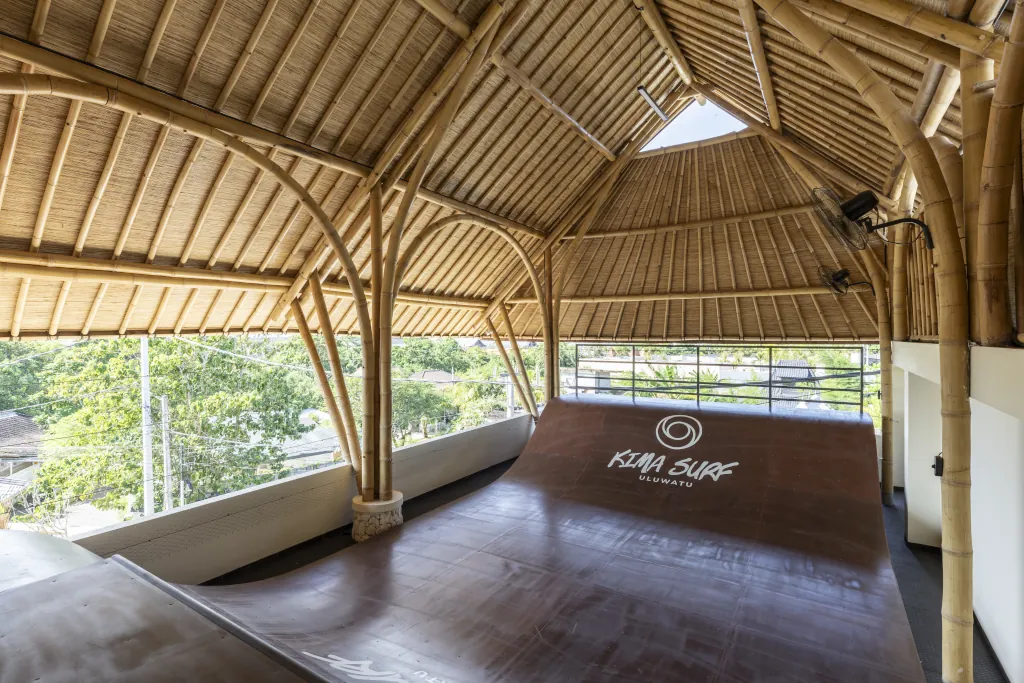 Kima Surfs surfskate area with a ramp and bamboo architecture roof top.