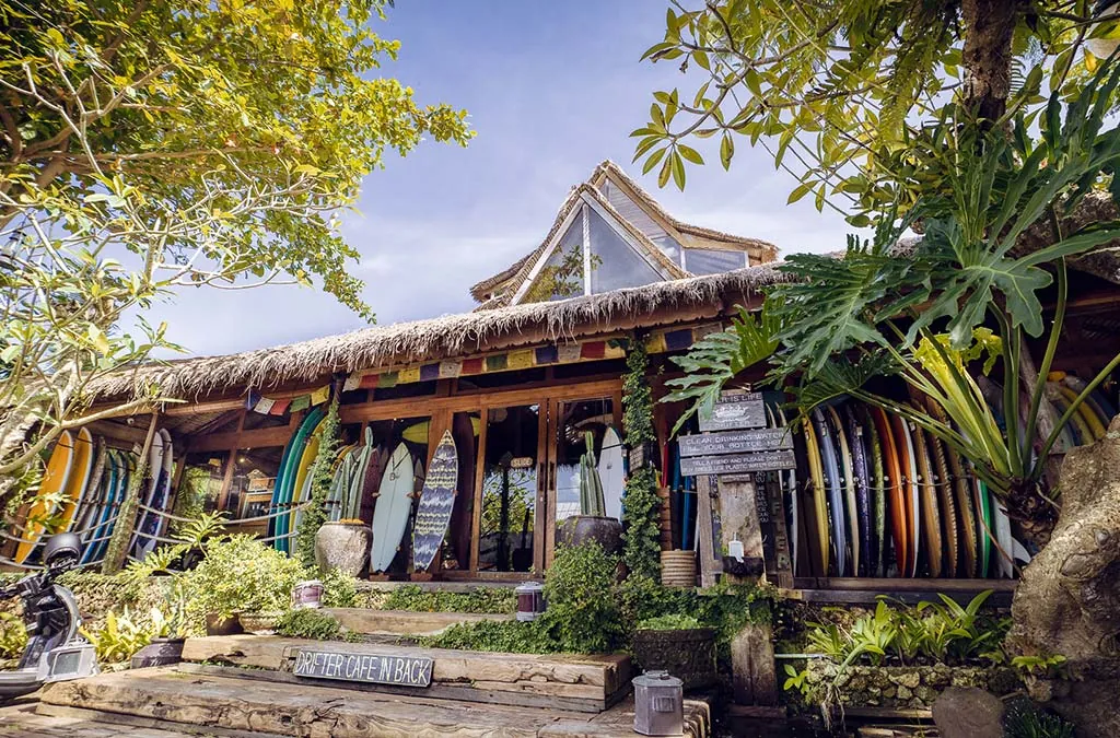 an image of drifters cafe from the front, bamboo style with chakra flags