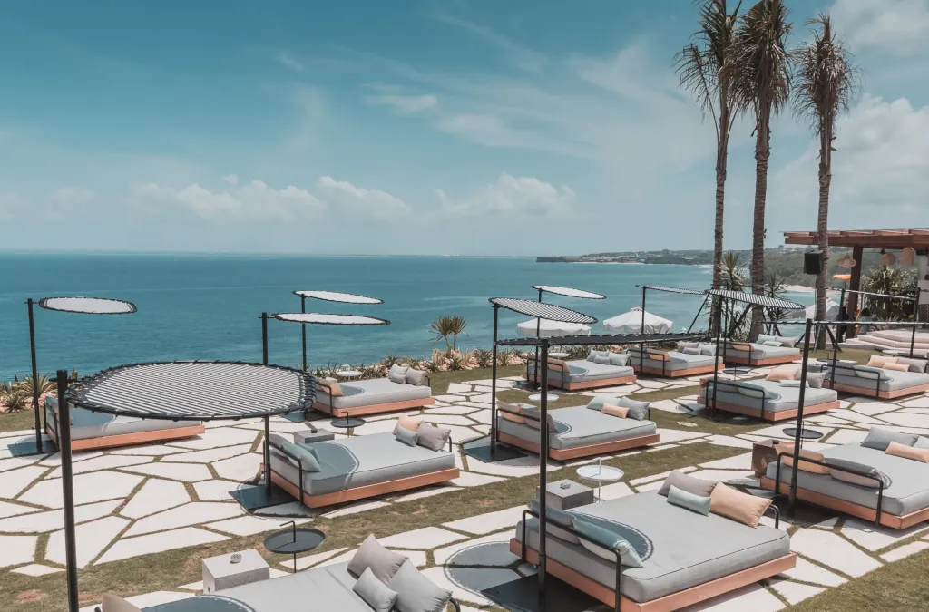 sun beds and dining tables on a limestone cliff overlooking the Indian ocean