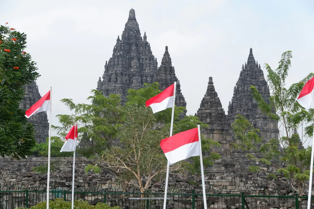 A bunch of Indonesian flags in front of a building