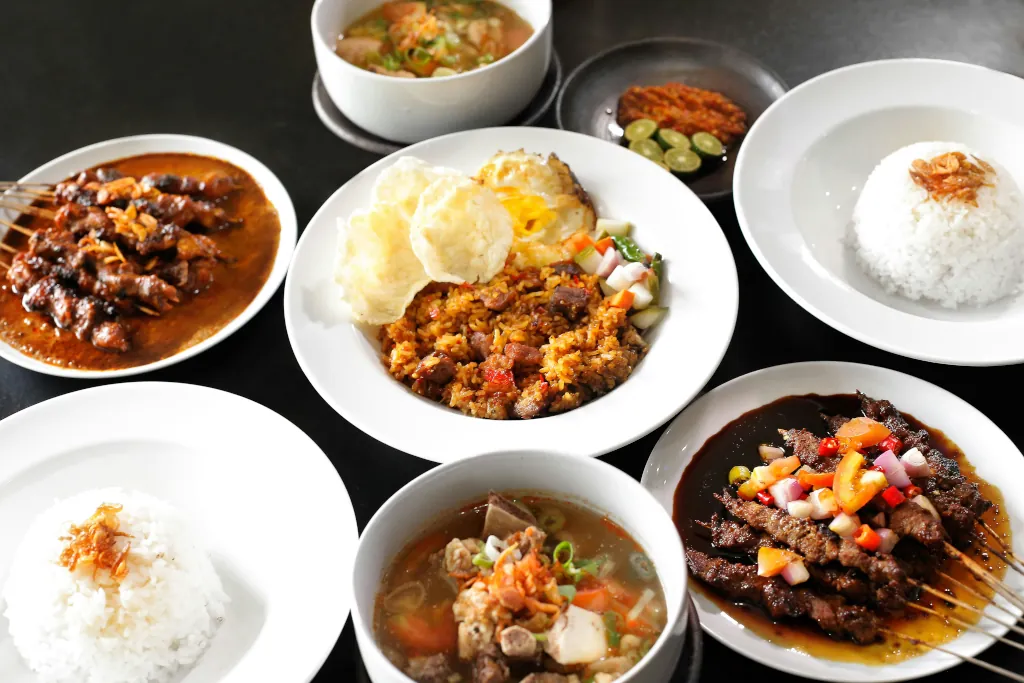 a variety of local indonesian food spread out on a table
