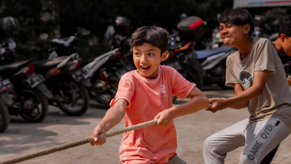 two young boys playing tug of war