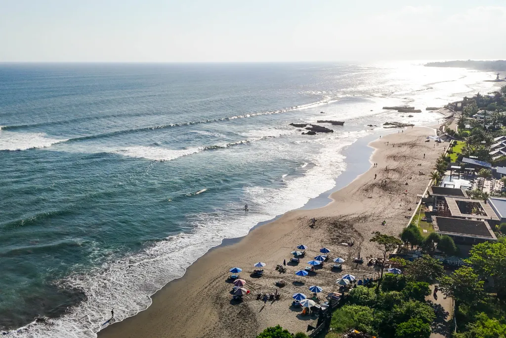 a drone shot of waves rolling into old mans