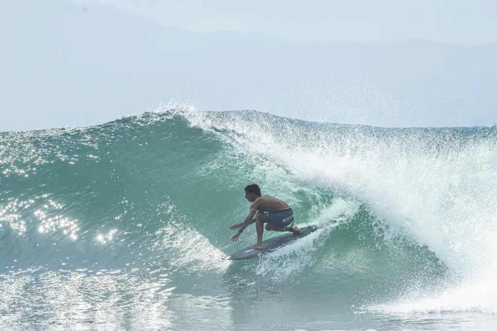a surfer tucking into a right-hand barrel