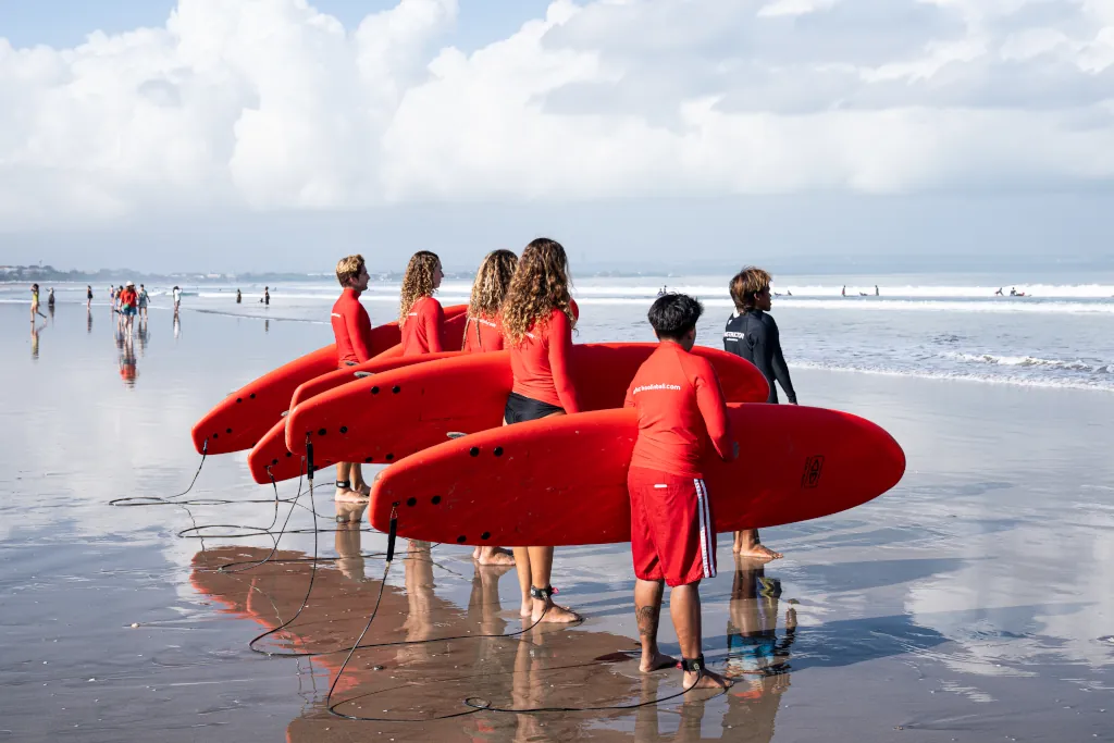 A man on a red surfboard catching a mellow wave