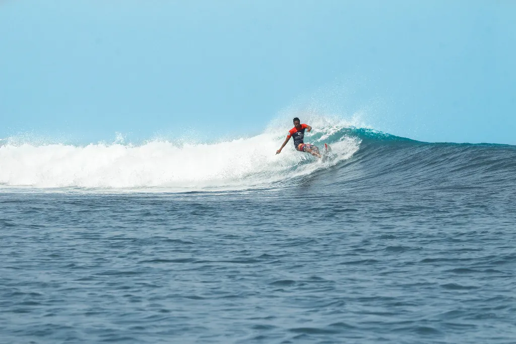 a man surfing a left hand wave