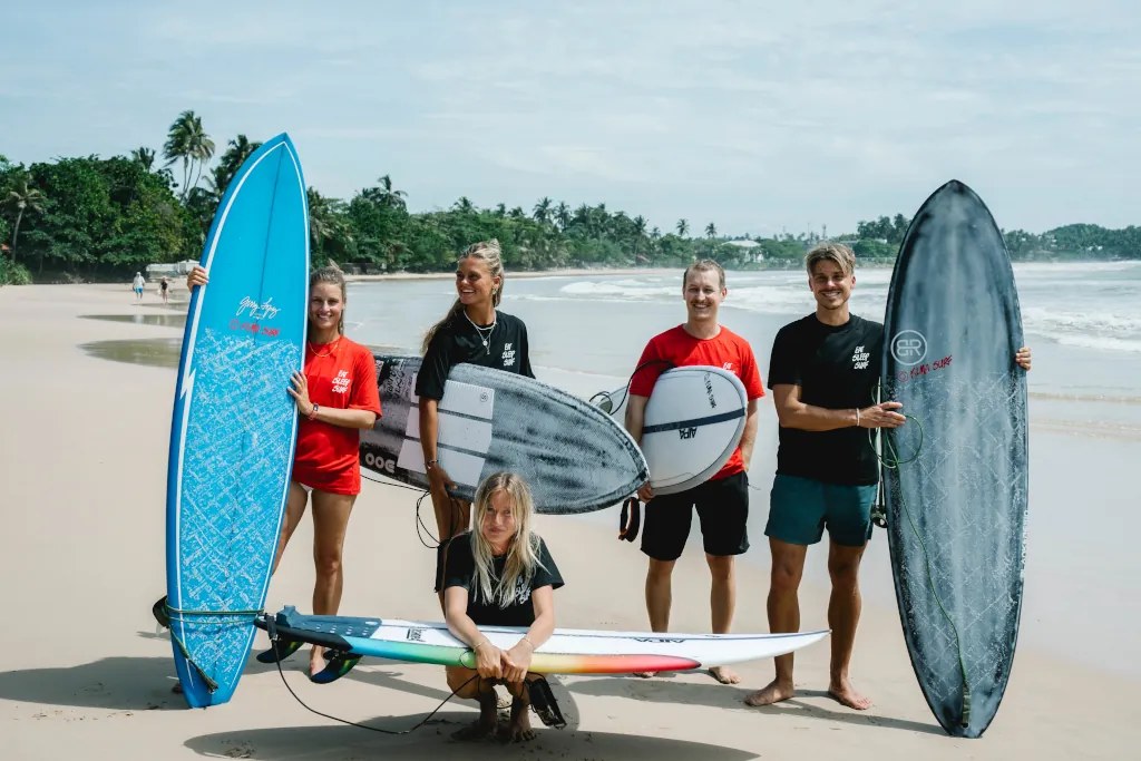 Group of Kima guests with their Premium surfboard from Kima's Premium Surfboard Collection.