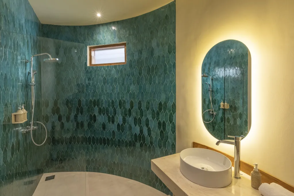 a beautiful blue tiled bathroom shower
