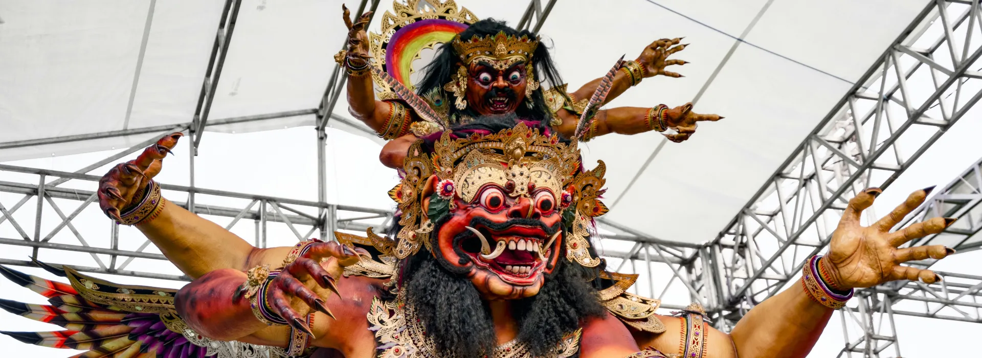 A large, multi-armed mythological creature with a fierce face