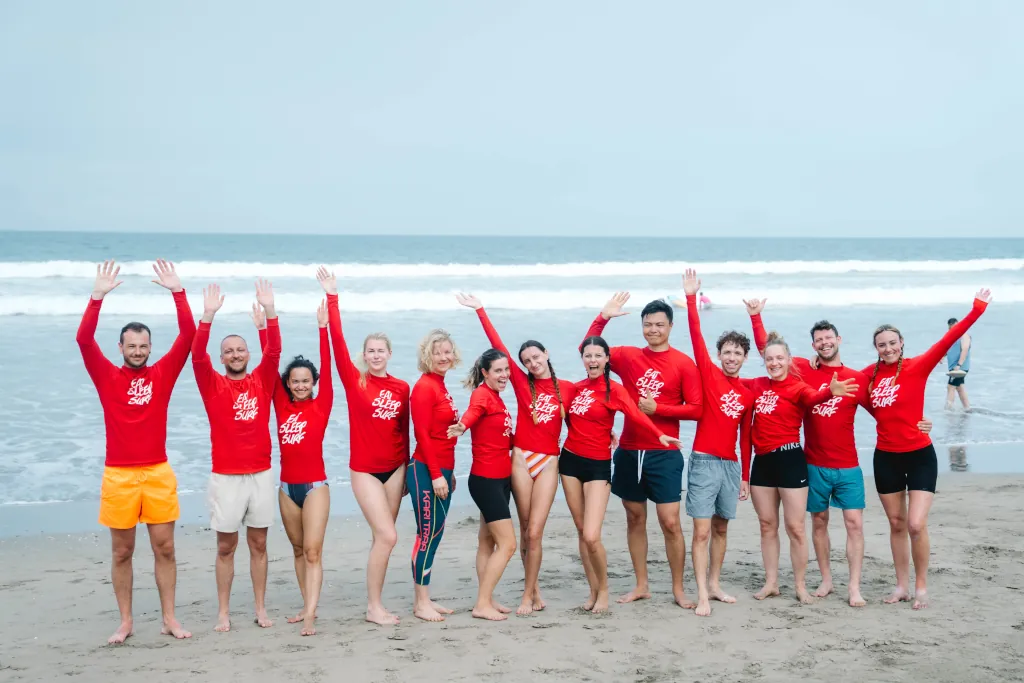 A GROUP OF PEOPLE SMILING ON THE BEACH