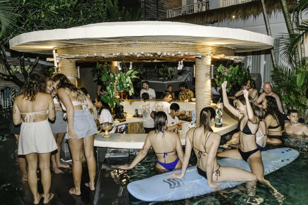 Many people dancing in the pool at a pool party in seminyak