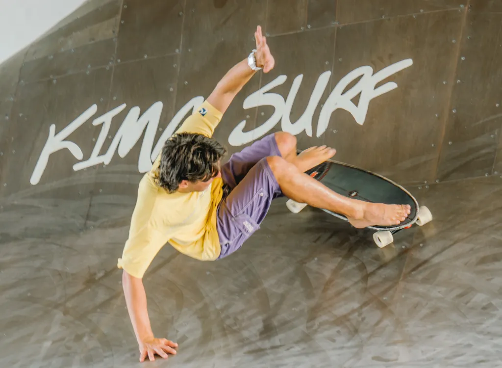A man surfing on a kima surf surf skate ramp