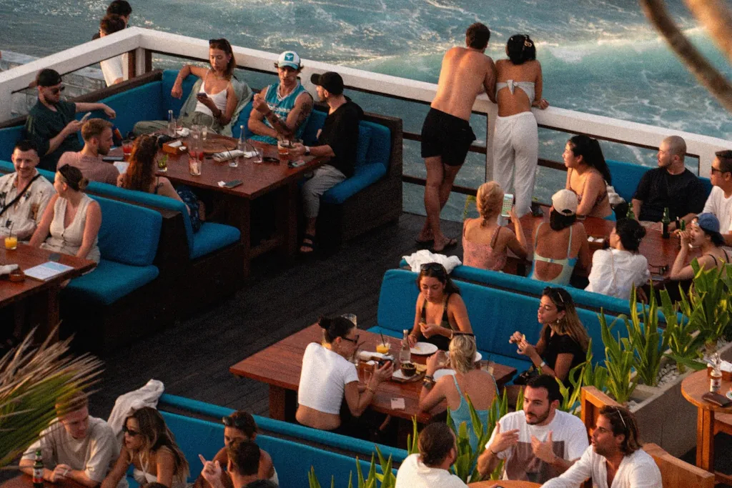 a bird eye view of people dining on a cliffside restuarant