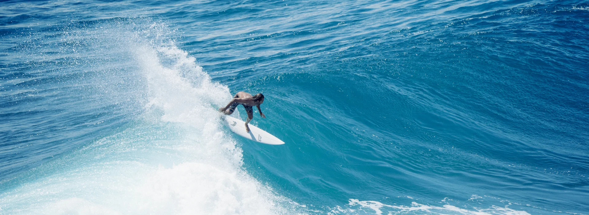 An intermediate surfer surfing a right-hand wave