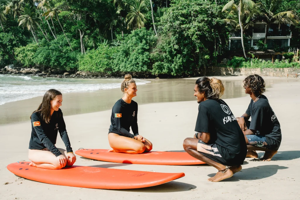 2 girls learning to surf on the beach