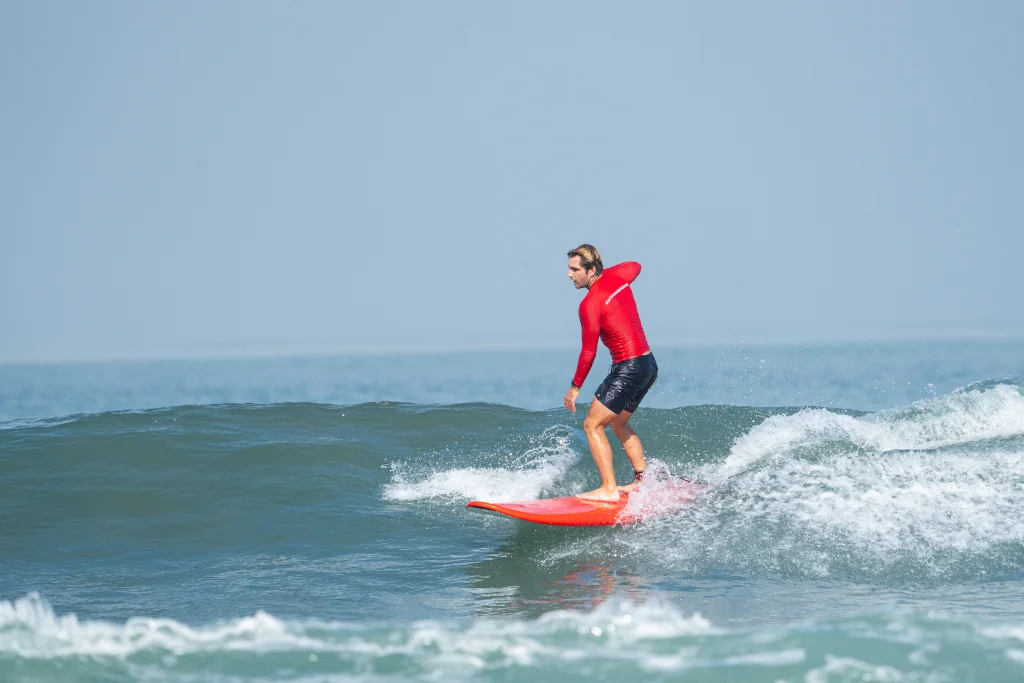 surfer catching a green wave