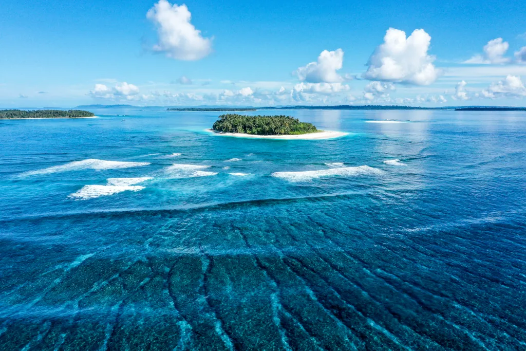 One small island with waves in the Mentawais
