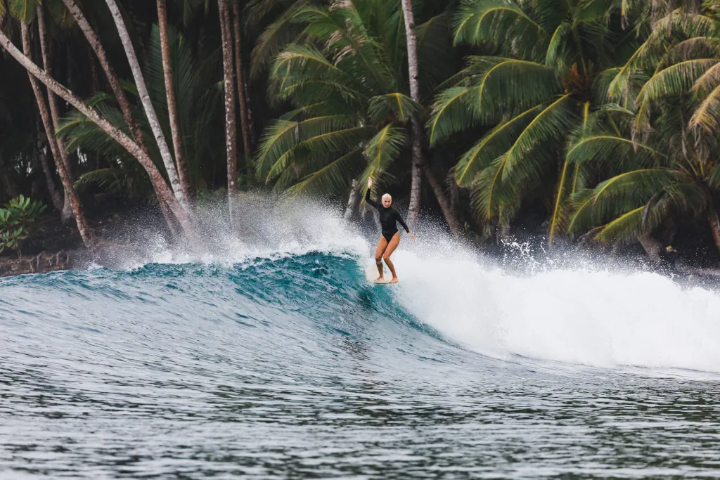 A woman on a long board hanging ten