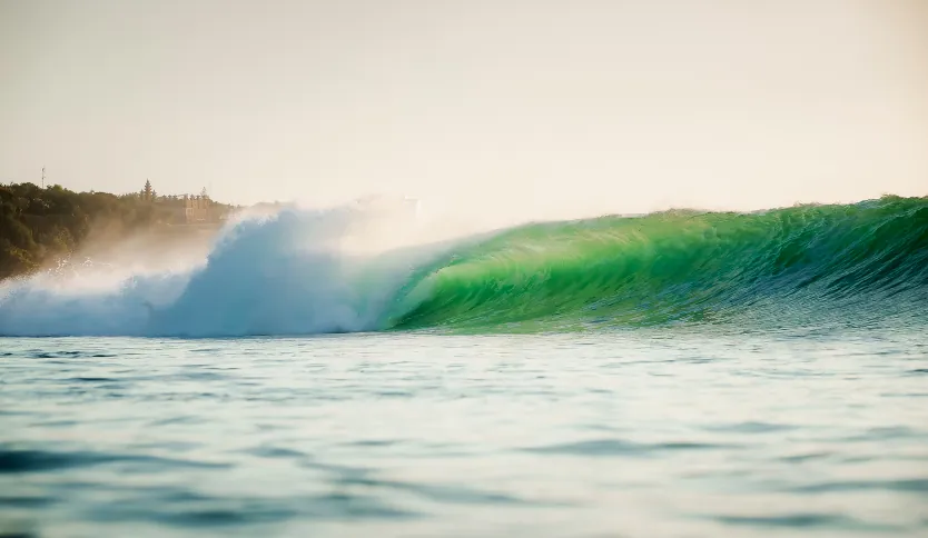Barrelling wave at Padang Padang Beach in Uluwatu shot from the water.